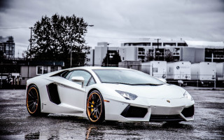 White orange sportscar parkinglot cloudy 2 - andrew law free wallpaper