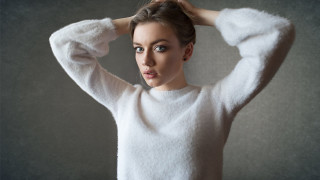 Woman white sweater holding hair - her hand behind her head free wallpaper