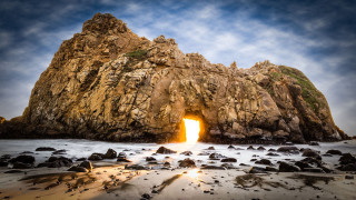 Large rock formation ocean light - a large rock formation free wallpaper