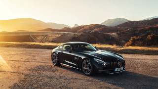Black sports car bridge mountains - matte free wallpaper
