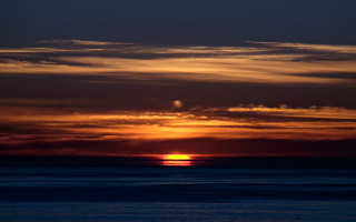 Sunset clouds boat ocean horizon 2 - the water below free wallpaper
