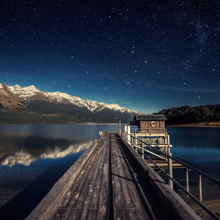 Pier night sky stars mountains - a mountain range in the background free wallpaper
