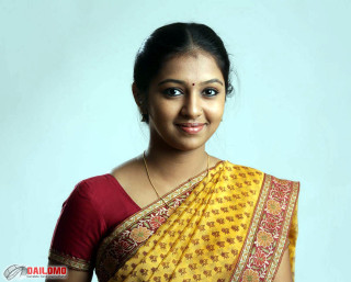 Woman yellow sari smiling camera - movie still frame free wallpaper
