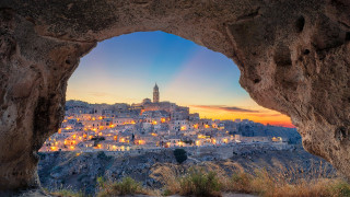 Mountain cave city lights autumn - a view of a town free wallpaper
