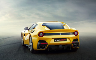Yellow sports car cloudy sky 3 - a black car in the foreground free wallpaper