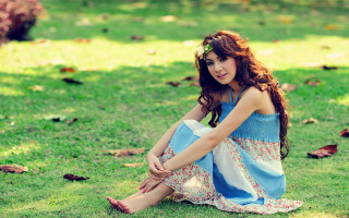 Woman sitting grass dress sandals 2 - naturalism free wallpaper