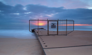 Gated beach sunset cloudy sky - institutional free wallpaper