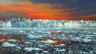 Icebergs sunset ocean reflection mountain - a red sky in the background free wallpaper