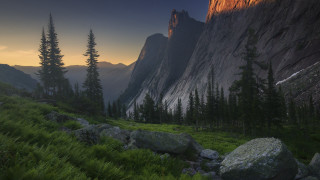 Mountain forest rocks sunset landscape - the foreground and a sunset in the background free wallpaper