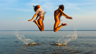 Two women jumping into water - two woman free wallpaper