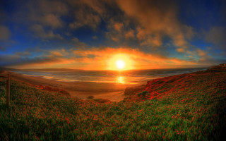 Sunset grassy hill water fence 2 - in the foreground free wallpaper