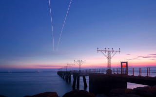 Pier plane sunset contrails water 3 - long exposure free wallpaper