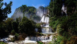 Waterfall boat trees bushes sunny - a sunny day free wallpaper