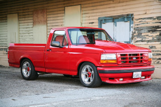 Red truck parked building door - a window open free wallpaper