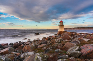 Lighthouse rocky shore cloudy sky 7 - the ocean in the background free wallpaper