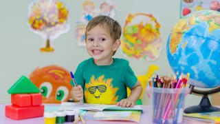 Young boy table book globe - front of him free wallpaper