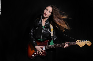 Woman guitar posing black background - a green skirt free wallpaper