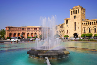 Fountain building rainbow bus cityscape - a rainbow in the middle of it free wallpaper