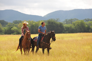 Man woman horses field mountains - a cloudy day free wallpaper