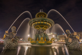 Fountain statues clock night lights - the water and a building in the background free wallpaper
