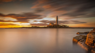 Lighthouse rocky shore sunset clouds 11 - a rocky shore free wallpaper
