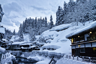 Snowy resort stream trees buildings - naive free wallpaper