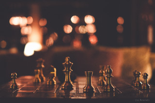 Chessboard chesspieces chair lights bokeh - a chair in the background free wallpaper