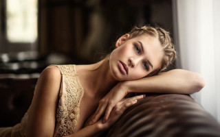 Woman laying leather couch portrait - bettina heinenayech free wallpaper