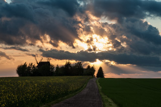 Dirt road windmill cloudy sky - crepuscular ray free wallpaper