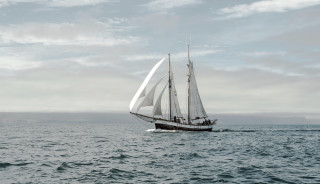 Sailboat ocean cloudy sky mountain - cinematic photography free wallpaper