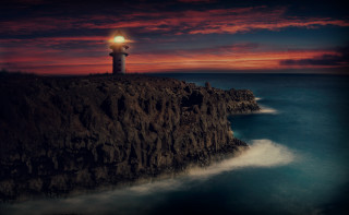 Lighthouse cliff red sky water - a lighthouse free wallpaper