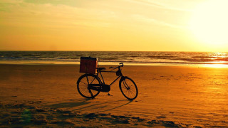 Bike beach sunset ocean gradient - the background and the ocean in the foreground free wallpaper