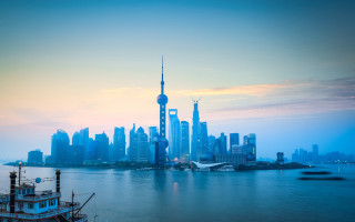 City skyline boat reflection sunset - the water and a boat in the foreground free wallpaper