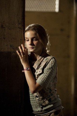 Young girl serious expression hand - free vintage wallpaper