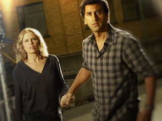 Man woman holding hands night - a building in the background free wallpaper