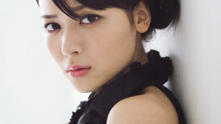 Woman black dress black bow - a white wall behind her free wallpaper