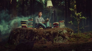 Man sitting pile books woods - free sci-fi wallpaper