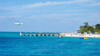 Plane beach pier umbrellas ocean - over a beach free wallpaper