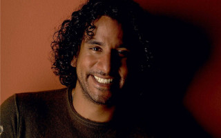 Man long hair smiling red - a red wall behind free wallpaper