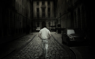 Man walking cobblestone street night - a matte painting free wallpaper