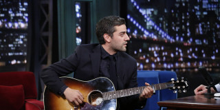 Man playing guitar sitting microphone - a microphone in the background free wallpaper
