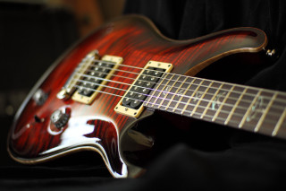 Red electric guitar black background - studio photography free wallpaper
