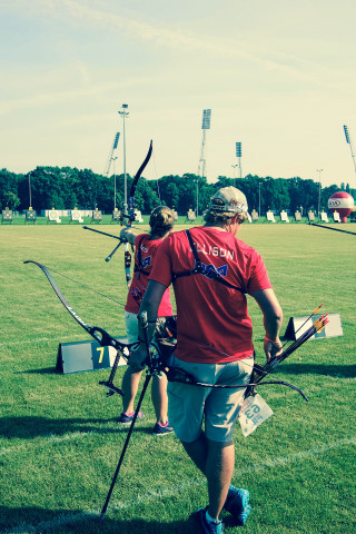 Man holding bow arrow field - boleslaw cybi free wallpaper