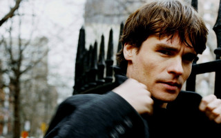 Man black fence serious look - dan scott free wallpaper