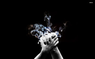 Hands holding smoke black background - a stock photo free wallpaper