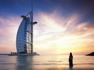 Woman standing water tall building - tall free wallpaper