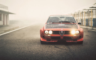 Red car driving road building - vintage free wallpaper