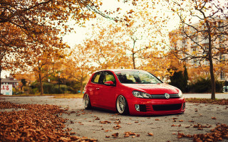 Red car parked street trees - a red car free wallpaper