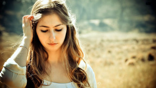 Woman field serious hands hair - a woman in a field free wallpaper