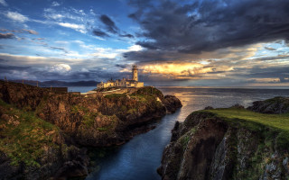 Lighthouse cliff ocean sunset cloudy 3 - a lighthouse free wallpaper